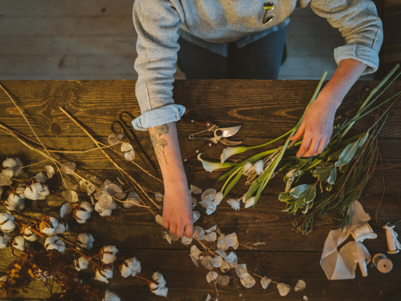 arranging flowers on a tabl